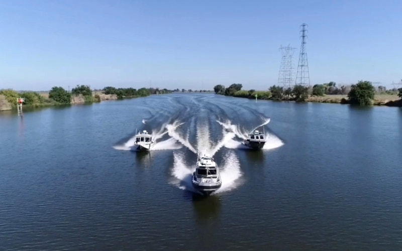 Three San Joaquin County Sheriff's Patrol Boats traveling on a waterway