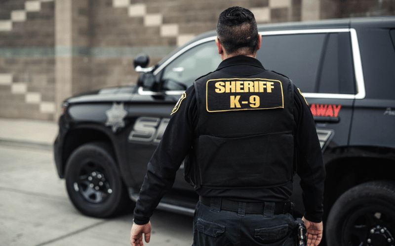 A San Joaquin County Sheriff's K9 Deputy walks to his patrol vehicle