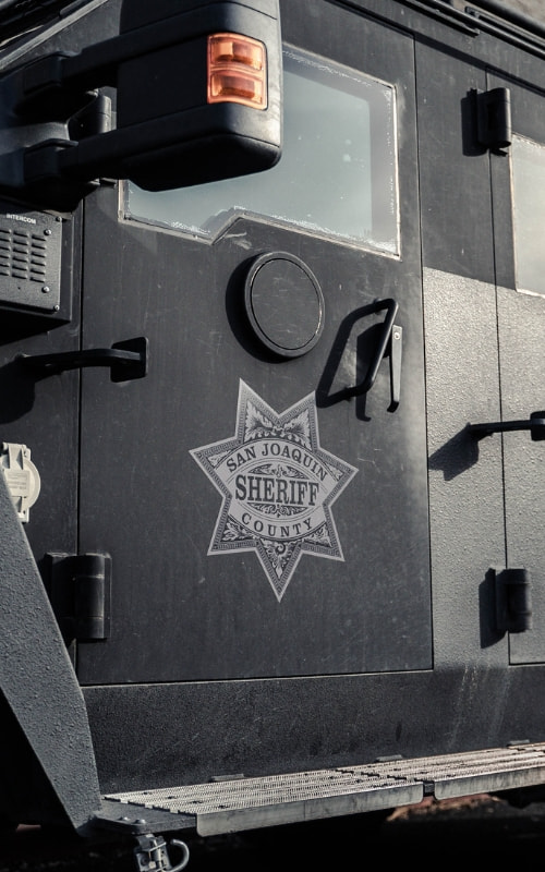 The San Joaquin County Sheriff's badge on the driver's door of a SWAT vehicle
